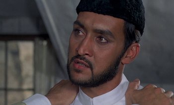 Movie still from “A Passage to India” (1984), directed by David Lean – A person wearing a hat; Close Up shot, Low angle