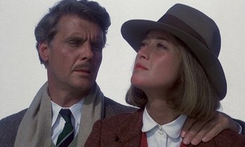 Movie still from “A Passage to India” (1984), directed by David Lean – A man and a woman standing next to each other; Close Up shot, Low angle