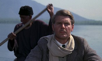 Movie still from “A Passage to India” (1984), directed by David Lean – A man in a boat with another man holding a stick; Close Up shot, Low angle