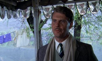 Movie still from “A Passage to India” (1984), directed by David Lean – A person wearing a suit and tie; Close Up shot, Low angle