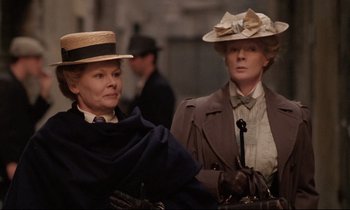 Movie still from “A Room with a View” (1985), directed by James Ivory – Two older women in hats and coats standing next to each other; Medium shot, Low angle