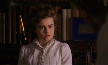 Movie still from “A Room with a View” (1985), directed by James Ivory – A young woman in a white shirt is looking at the camera; Close Up shot, Over the shoulder angle