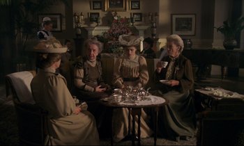 Movie still from “A Room with a View” (1985), directed by James Ivory – A group of people sitting around a table; Medium shot, High angle