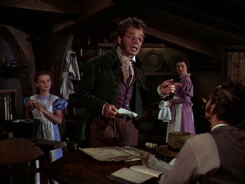 Movie still from “A Song to Remember” (1945), directed by Charles Vidor – A group of people standing around a table; Medium shot, Low angle