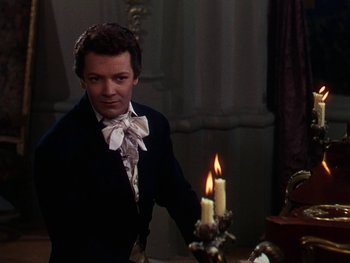 Movie still from “A Song to Remember” (1945), directed by Charles Vidor – A man standing next to a candle in a dark room; Medium shot, Over the shoulder angle