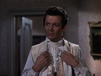 Movie still from “A Song to Remember” (1945), directed by Charles Vidor – A man adjusting his neck tie while standing in front of a mirror; Close Up shot, Over the shoulder angle