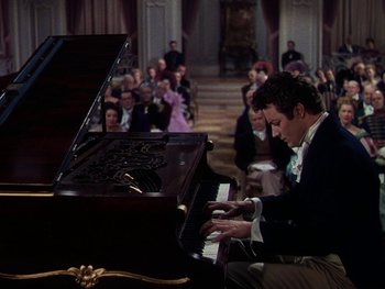 Movie still from “A Song to Remember” (1945), directed by Charles Vidor – A man sitting at a grand piano in front of an audience; Medium shot, High angle