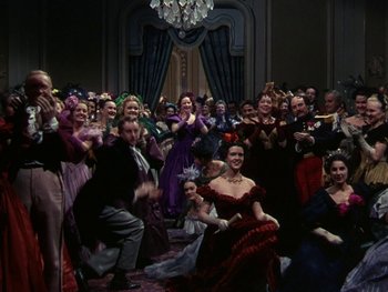 Movie still from “A Song to Remember” (1945), directed by Charles Vidor – A group of people dressed in period costumes; Wide shot, Low angle