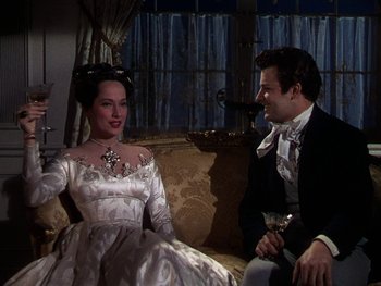 Movie still from “A Song to Remember” (1945), directed by Charles Vidor – A man and a woman sitting next to each other on a couch; Medium shot, Over the shoulder angle