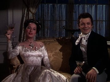 Movie still from “A Song to Remember” (1945), directed by Charles Vidor – A man and a woman sitting next to each other on a couch; Medium shot, Low angle