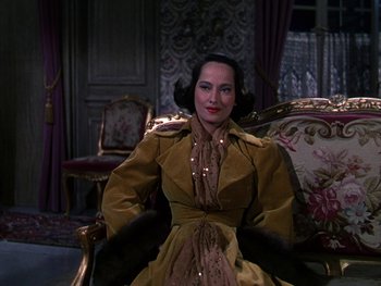 Movie still from “A Song to Remember” (1945), directed by Charles Vidor – A woman sitting on a chair in a room; Medium shot, High angle