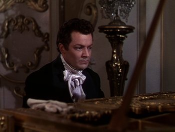 Movie still from “A Song to Remember” (1945), directed by Charles Vidor – A man sitting at a table in front of a mirror; Medium shot, High angle