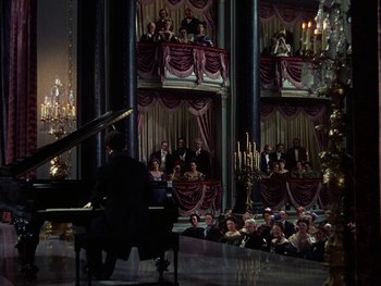 Movie still from “A Song to Remember” (1945), directed by Charles Vidor – A man sitting at a grand piano in front of a crowd; Extreme Wide shot, High angle