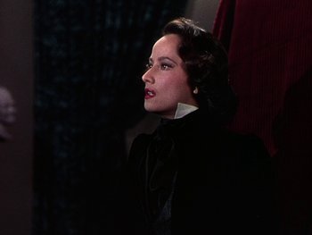Movie still from “A Song to Remember” (1945), directed by Charles Vidor – A woman wearing a black suit and a white collar; Close Up shot, Over the shoulder angle