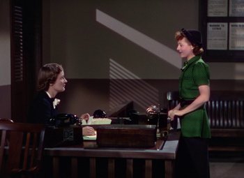 Movie still from “A Star Is Born” (1937), directed by Victor Fleming – Two women are sitting at a table talking to each other; Medium shot, High angle
