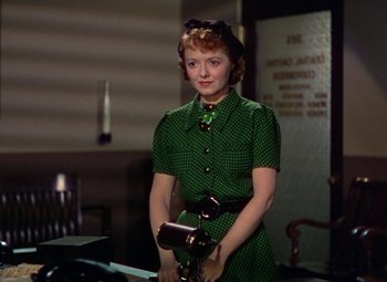 Movie still from “A Star Is Born” (1937), directed by Victor Fleming – A woman in a green dress holding a purse; Medium shot, Low angle