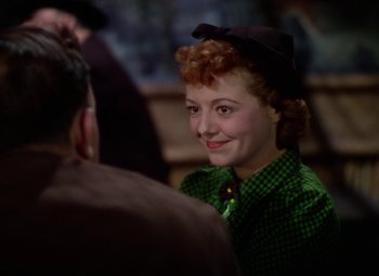 Movie still from “A Star Is Born” (1937), directed by Victor Fleming – A woman in a green shirt is smiling at a man; Close Up shot, Over the shoulder angle