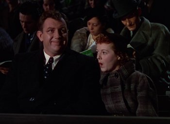 Movie still from “A Star Is Born” (1937), directed by Victor Fleming – A man and a woman sitting next to each other; Medium shot, Low angle