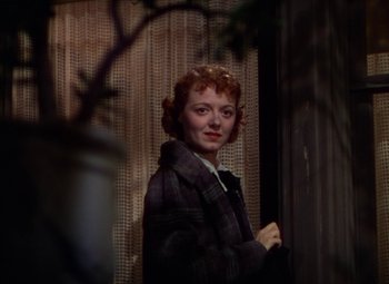 Movie still from “A Star Is Born” (1937), directed by Victor Fleming – A woman standing in front of a window; Close Up shot, Low angle