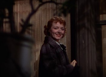 Movie still from “A Star Is Born” (1937), directed by Victor Fleming – A woman standing in front of a window; Close Up shot, Low angle