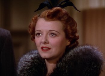 Movie still from “A Star Is Born” (1937), directed by Victor Fleming – An older woman wearing a fur coat with a black bird on her head; Close Up shot, Low angle