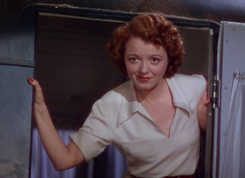 Movie still from “A Star Is Born” (1937), directed by Victor Fleming – A woman in a white shirt is posing for a picture; Close Up shot, Low angle