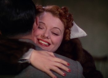 Movie still from “A Star Is Born” (1937), directed by Victor Fleming – A woman is hugging a man while she is smiling; Close Up shot, Low angle
