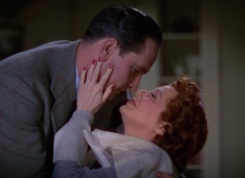 Movie still from “A Star Is Born” (1937), directed by Victor Fleming – A man and a woman are kissing in a room; Close Up shot, Low angle