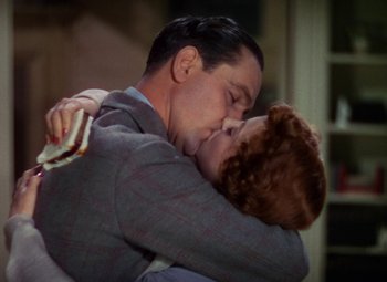 Movie still from “A Star Is Born” (1937), directed by Victor Fleming – A man and a woman embracing each other; Close Up shot, Low angle