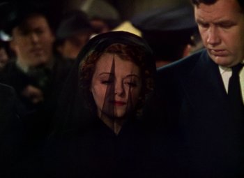 Movie still from “A Star Is Born” (1937), directed by Victor Fleming – A woman in a black dress with a veil over her face; Close Up shot, High angle