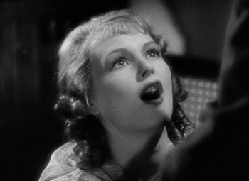 A black - and - white photo of a woman looking up