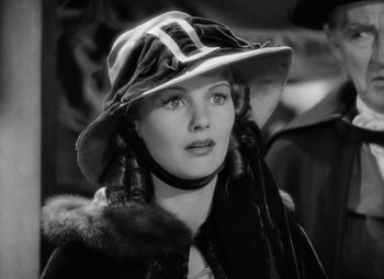 Movie still from “A Tale of Two Cities” (1935), directed by Jack Conway – A black and white photo of a woman wearing a hat; Close Up shot, Over the shoulder angle
