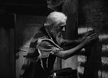 Movie still from “A Tale of Two Cities” (1935), directed by Jack Conway – An old man with long white hair and a long beard; Medium shot, Low angle