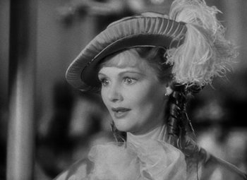 Movie still from “A Tale of Two Cities” (1935), directed by Jack Conway – A black and white photo of a woman wearing a hat; Close Up shot, Over the shoulder angle