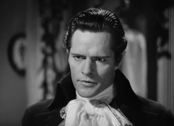 Movie still from “A Tale of Two Cities” (1935), directed by Jack Conway – A black and white photo of a man in a costume; Close Up shot, High angle