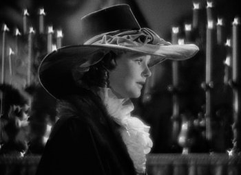 Movie still from “A Tale of Two Cities” (1935), directed by Jack Conway – A black and white photo of a woman wearing a hat; Close Up shot, High angle