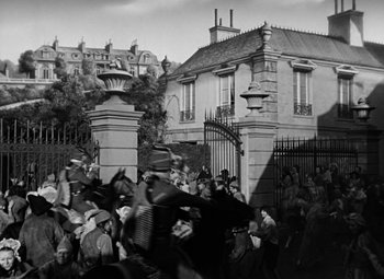 Movie still from “A Tale of Two Cities” (1935), directed by Jack Conway – A group of people standing in front of a building; Extreme Wide shot, High angle