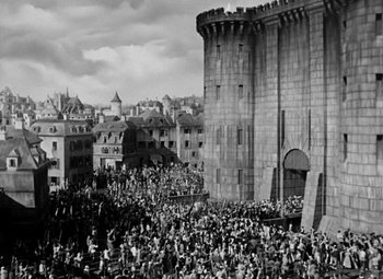 Movie still from “A Tale of Two Cities” (1935), directed by Jack Conway – A crowd of people standing in front of a building; Extreme Wide shot, High angle