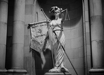 Movie still from “A Tale of Two Cities” (1935), directed by Jack Conway – A statue of lady justice holding the scales of justice; Wide shot, Low angle