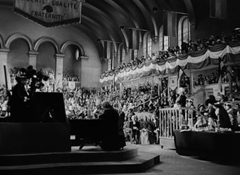 Movie still from “A Tale of Two Cities” (1935), directed by Jack Conway – An old photo of a crowd of people in a building; Extreme Wide shot, High angle