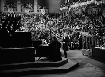 Movie still from “A Tale of Two Cities” (1935), directed by Jack Conway – An old photo of a man sitting at a piano in front of an audience; Extreme Wide shot, High angle