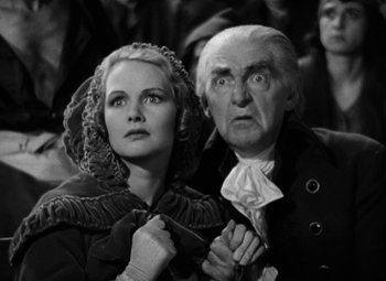 Movie still from “A Tale of Two Cities” (1935), directed by Jack Conway – An older man and woman looking at the camera; Medium shot, Low angle