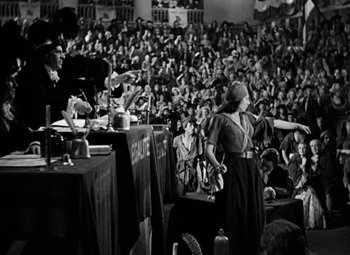 Movie still from “A Tale of Two Cities” (1935), directed by Jack Conway – An old photo of a woman giving a speech in front of a crowd; Wide shot, High angle