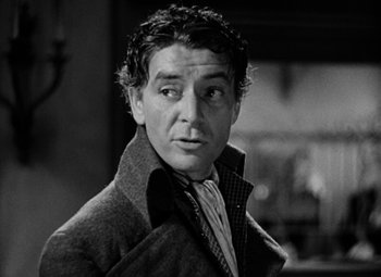 Movie still from “A Tale of Two Cities” (1935), directed by Jack Conway – An old black and white photo of a man in a jacket; Close Up shot, Low angle