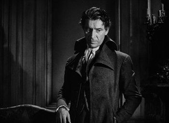 Movie still from “A Tale of Two Cities” (1935), directed by Jack Conway – A black and white photo of a man in a trench coat; Medium shot, Low angle