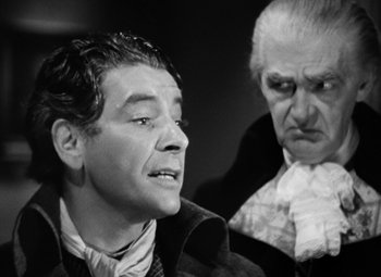 Movie still from “A Tale of Two Cities” (1935), directed by Jack Conway – A man and a man wearing a suit and tie; Close Up shot, Over the shoulder angle