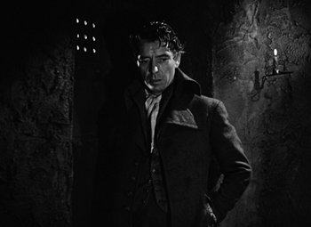 Movie still from “A Tale of Two Cities” (1935), directed by Jack Conway – A black and white photo of a man in a coat; Medium shot, Low angle