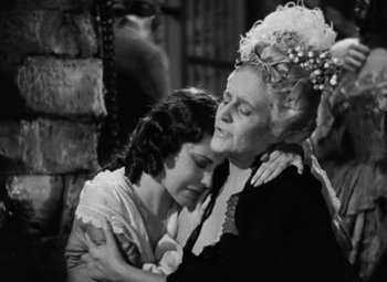 Movie still from “A Tale of Two Cities” (1935), directed by Jack Conway – A woman and a girl embracing each other; Medium shot, Low angle