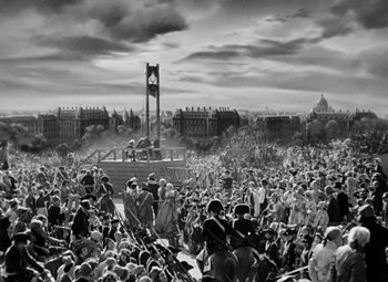 Movie still from “A Tale of Two Cities” (1935), directed by Jack Conway – A large crowd of people gathered in a park; Extreme Wide shot, High angle