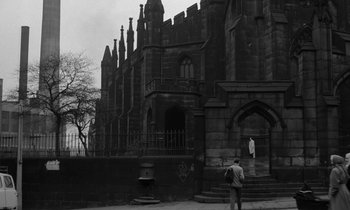 A man standing in front of an old building